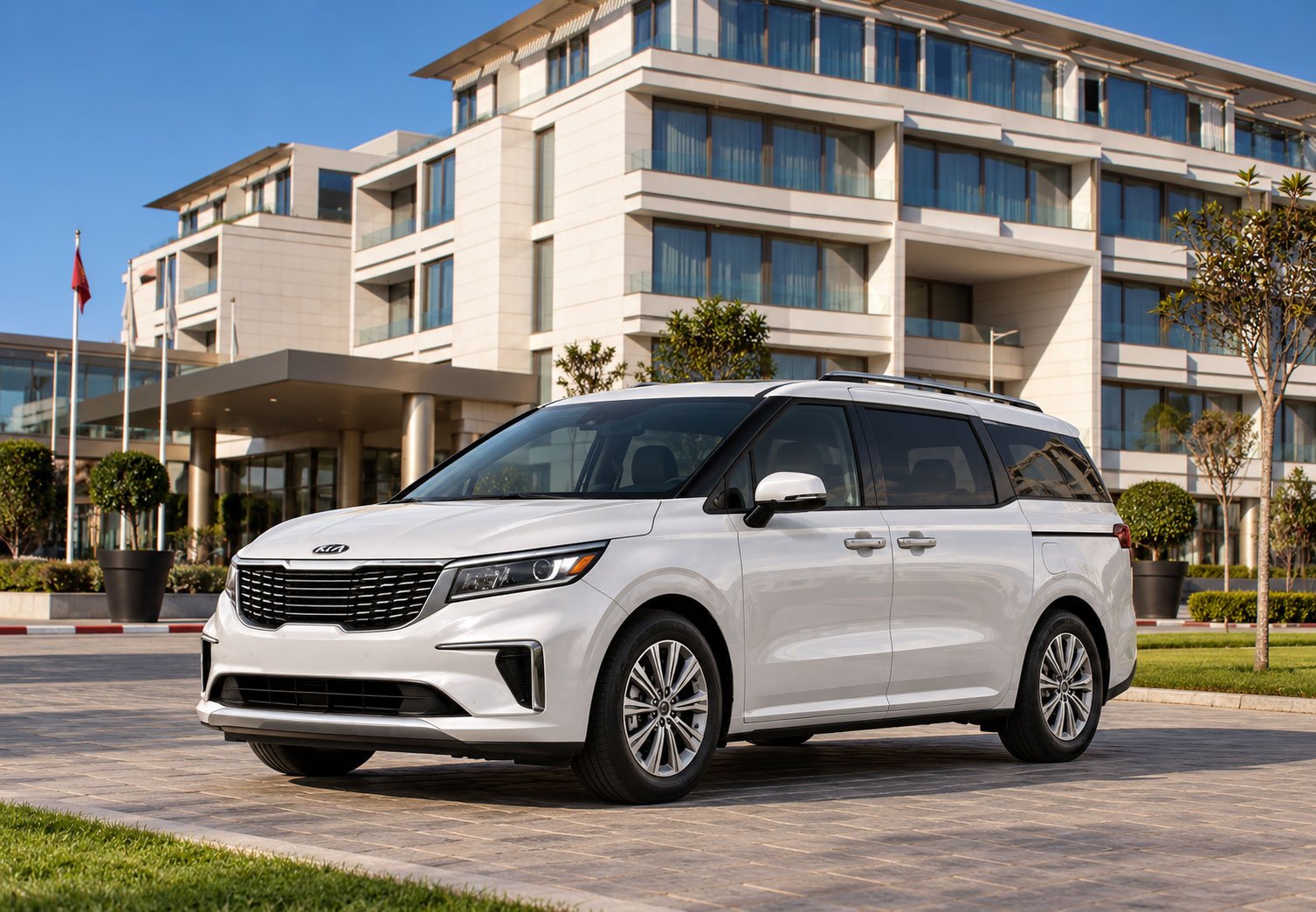 Location Kia Carnival 2 Luxury-Minivan-at-Modern-Hotel-Entrance